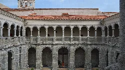 Cloister with stone arches and columns in Calera de León.