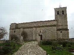 San Millán Church in Velliza, with tower and stone facade.