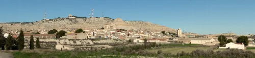 Panoramic view of La Almolda from the cemetery with hills and buildings.