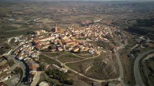 Aerial view of a town with buildings and roads in a rural landscape.