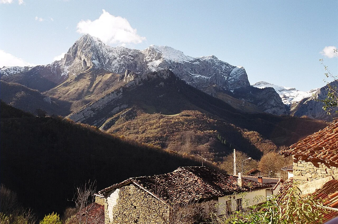Snow-capped mountains and houses in Ponga, Asturias.