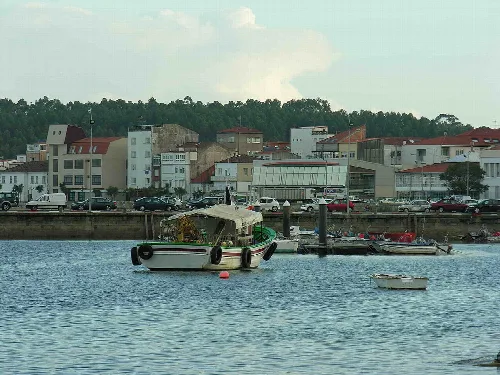 Boats and buildings at Puebla del Caramiñal harbor.