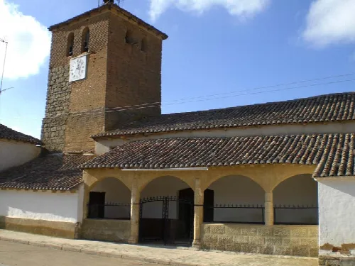 Church with brick tower and clock in Arconada, Palencia.