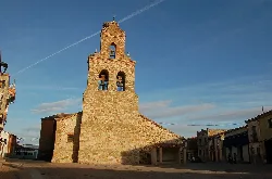 Stone church with tower and bell tower in Manganeses de la Lampreana.