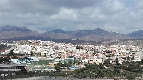 Vista de Olula del Río con montañas y edificios blancos.
