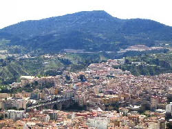 Aerial view of Alcoy with mountains and city in the foreground.