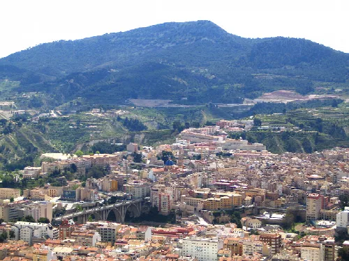 Aerial view of Alcoy with mountains and city in the foreground.