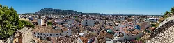 View of Dénia from the castle, showing buildings and the sea.