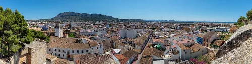 View of Dénia from the castle, showing buildings and the sea.
