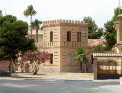 Brick tower building with trees in San Pedro del Pinatar.