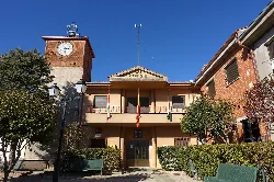 Town hall building with clock and flags in Salamanca.