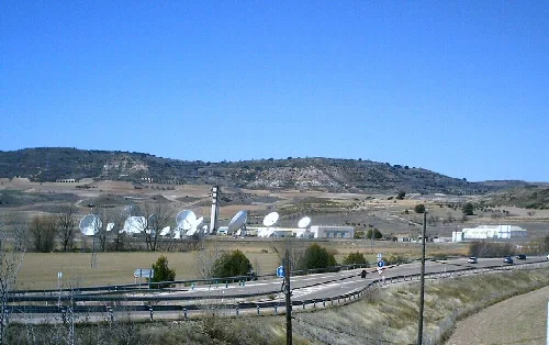 Parabolic antennas and satellites in a field in Armuña de Tajuña.