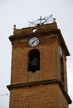 Brick tower with clock and bell at the top, in Casalarreina.
