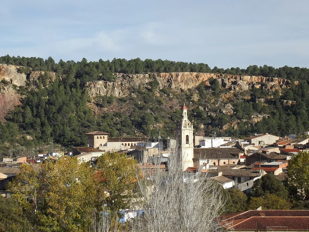 View of a town with church and green hills.