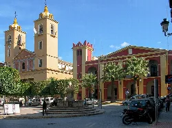 Square with church, town hall, palms, and fountain in Berja, Almería.
