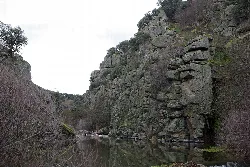 River with rocks and vegetation along its banks near Mingorría.
