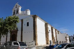 White church with tower and simple facade in Villanueva del Fresno.