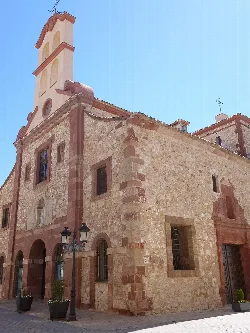 Stone facade and bell tower of the church in Campo de Criptana.