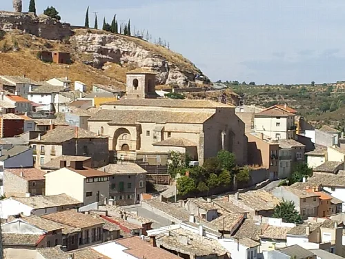 Parish church of Santa Eulalia of Mérida in Peñalver, surrounded by houses.