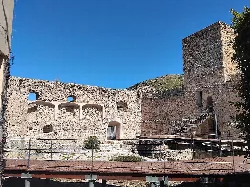 Ruins of the castle of Doña Mencía, with stone walls and stairs.