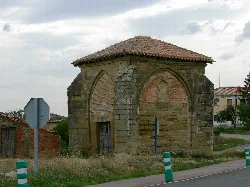 Small stone chapel with red tiled roof in Grañón.