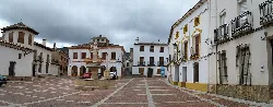 Square with fountain in the center and white buildings in Bienservida.