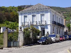 White house with iron balconies and garden in Boal.
