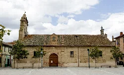 Front view of Santiago Apostle church with bell tower in Navas de Oro.