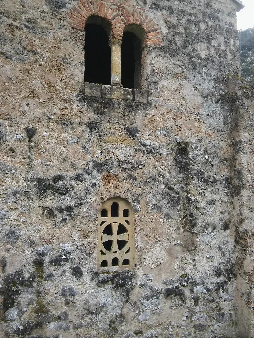Óculos geminado en la pared de una iglesia antigua en Santo Adriano.