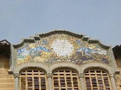 Facade with sundial and frescoes on top of a building in Sant Feliu de Guíxols.