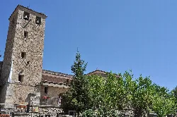 Stone tower and trees in Madrigal de la Vera.