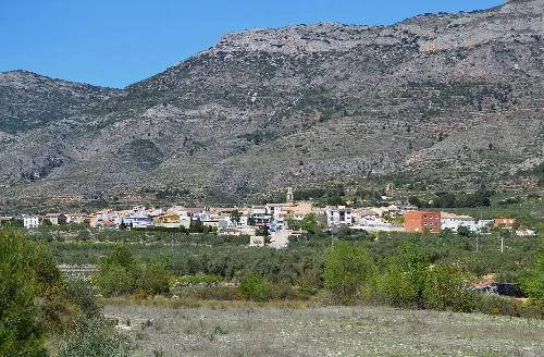 Pueblo de Gayanes con montañas y vegetación en el fondo.