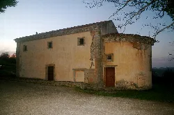 Santa María de Junco church in Ribadesella, with stone walls and simple structure.