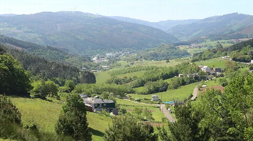 Panoramic view of Riotorto with green hills and scattered houses.