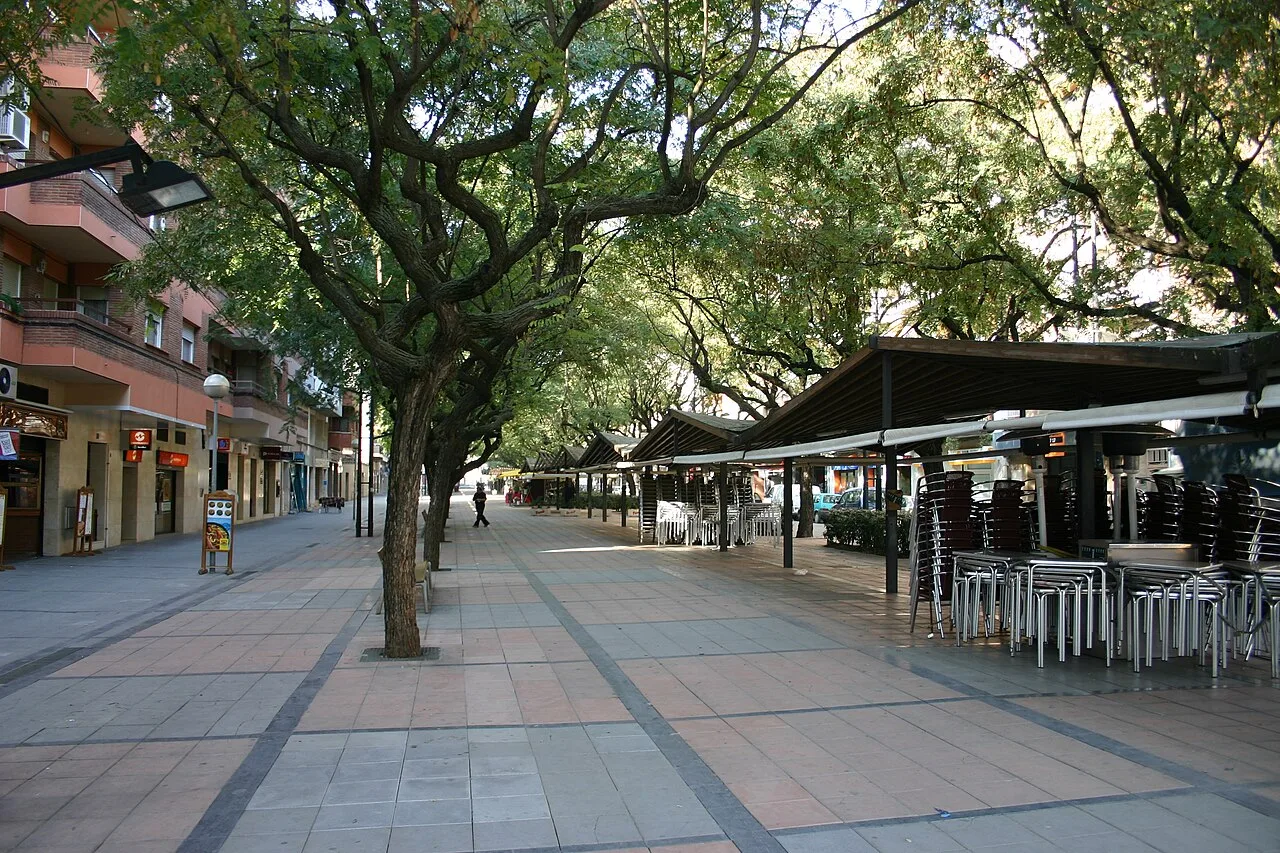 A calle peatonal con árboles y terrazas de bares en Viladecans.