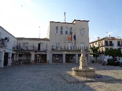 Square with town hall building and fountain in the center