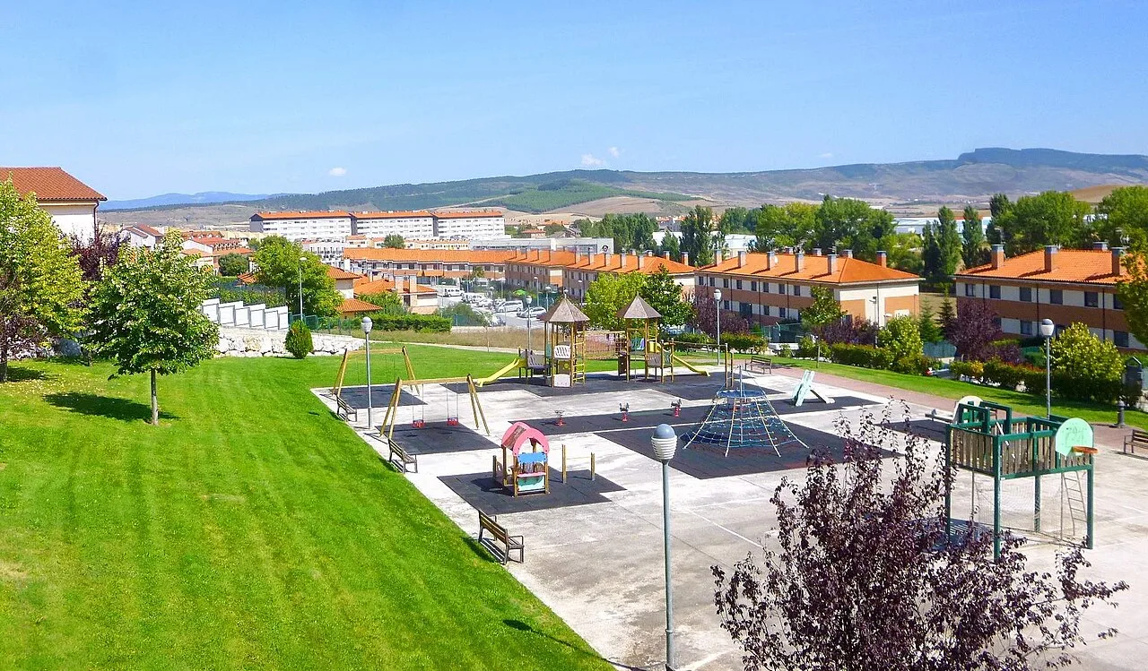 Playground and park in Beriáin, Navarra, with hills in the background.