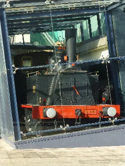Steam locomotive displayed in a glass case at the museum.