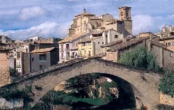Stone bridge with houses and church in Estella