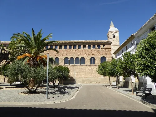 Church with bell tower and trees in Nuez de Ebro.