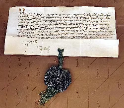 Pergamino antiguo con sello de cera verde y texto en romance navarro.