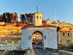 Entrance gate with church and bridge in Pinos Puente, Granada.