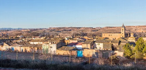 Houses and a church in Mozota, Zaragoza, on a clear day.