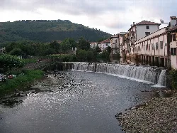 Bidasoa river with houses and waterfall in Elizondo.