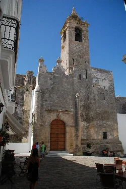 Church facade with tower and clock in Vejer de la Frontera.