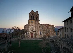 San Vicente Church in Frías with tower and stone facade.