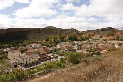 Panoramic view of Abajas with houses and hills in the background.