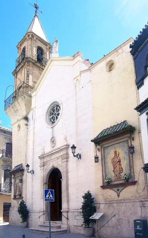Weiße Kirchenfassade mit Turm und Statue in Córdoba.