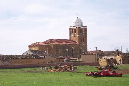 Church with dome and village houses in San Román de la Cuba, Palencia.