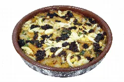 Antruejo soup in a clay bowl with various ingredients.